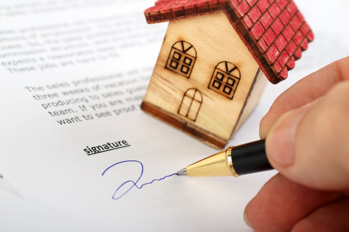 New homeowner signing contract of house sale